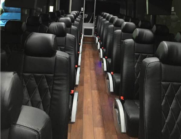 Coach seats reupholstered in black leather with diamond stitching